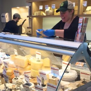 Mary Tuthill and Kevin Wood prepare samples for visitors at the Mad River Taste Place.