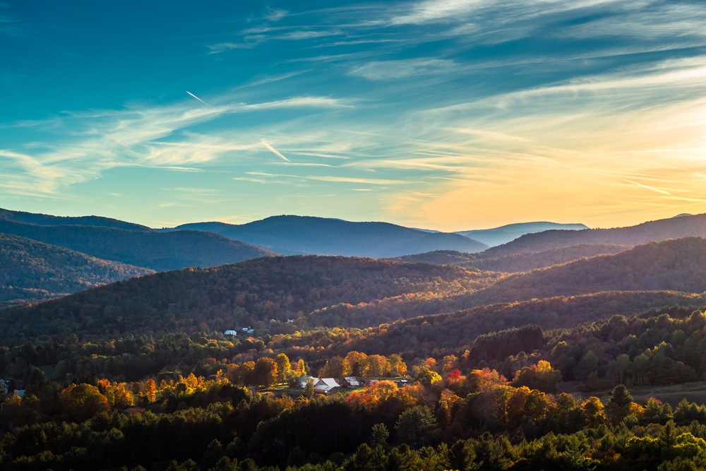 Mad River Valley of Vermont, beautiful photo of the scenic valley at sunset with rolling hills of green and golds 