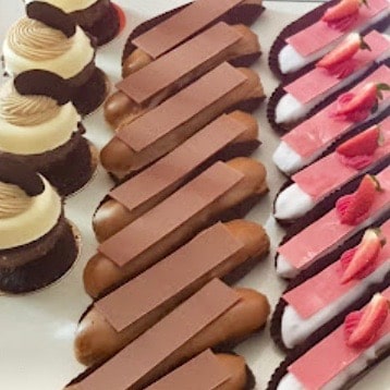 French pastries on display on a shop shelf.